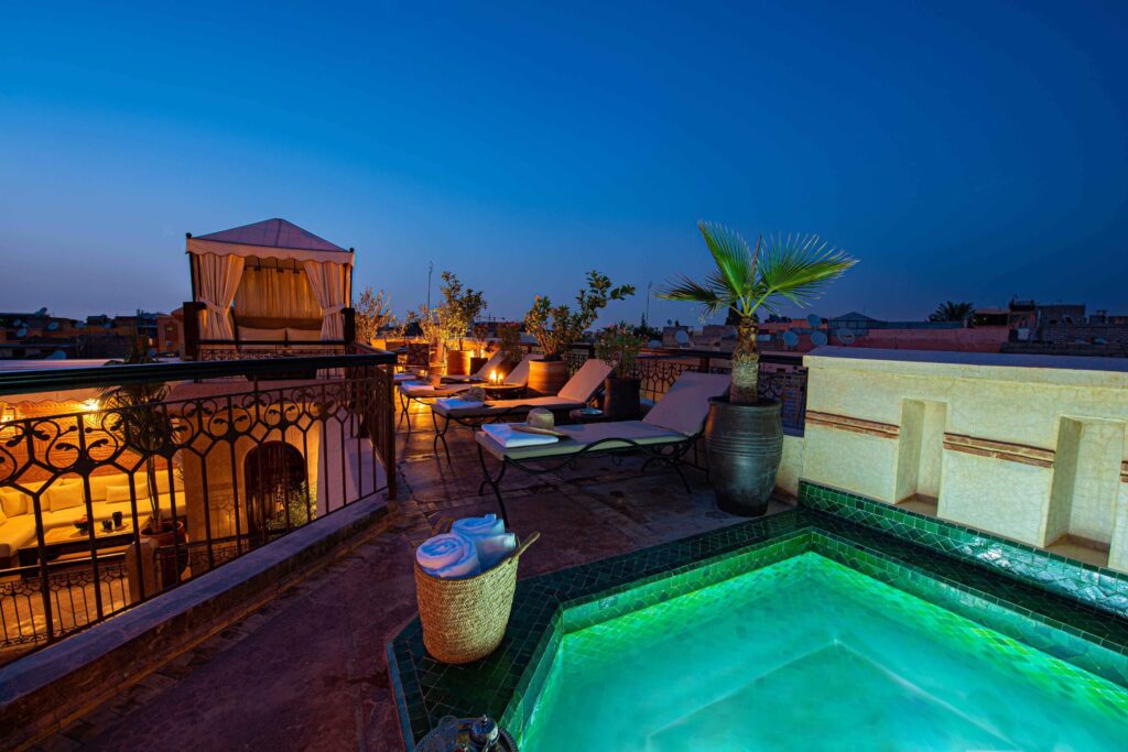 A plunge pool and sunloungers on the rooftop terrace of Riad Livia in Marrakech