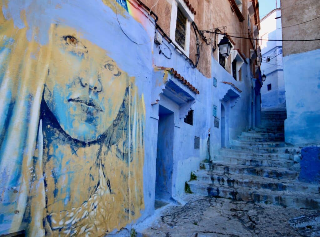 A mural in a blue-washed street of the Chefchaouen medina