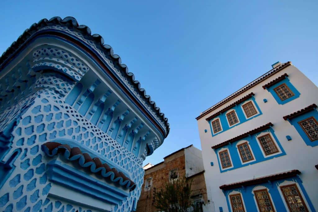 Colourful buildings against a bright blue sky in Chefchaouen, which offers a relaxed atmosphere for solo travellers