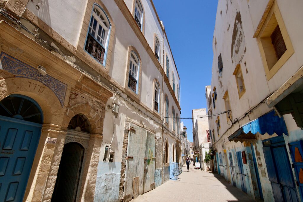 Blue and white buildings frame a street in Essaouira - a popular destination for Marrakech day trips