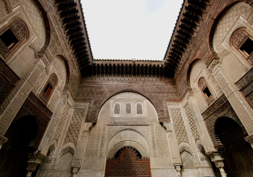 Intricate detailing on the walls of Al Attarine Madrasa in Fes, Morocco