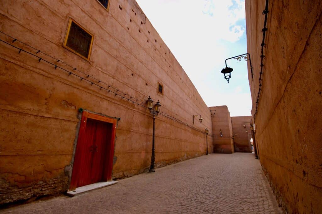 Ochre walls line a street in the Marrakech medina where street harassment sometimes occurs