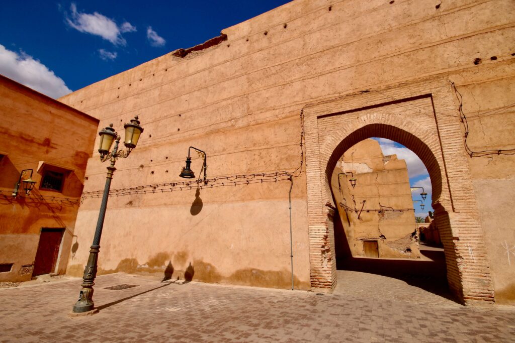 An archway in an ochre-hued wall of the Marrakech medina