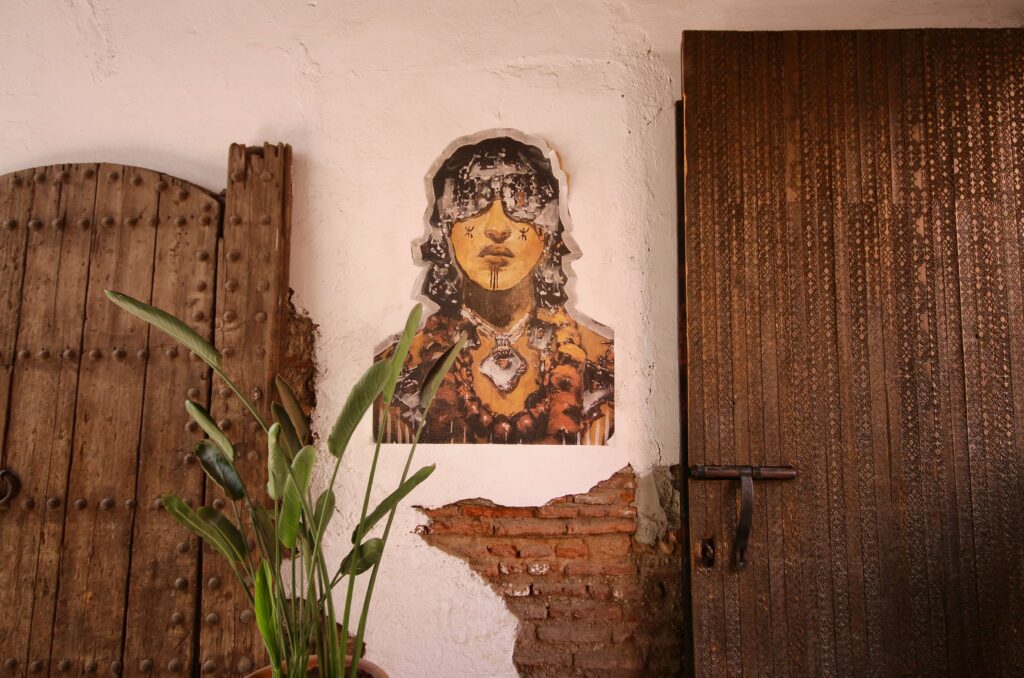 Street art between two ornate wooden doors in the Marrakech medina