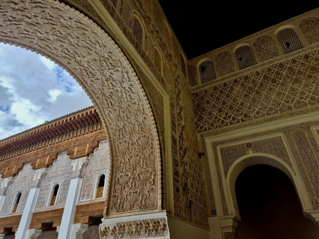 Intricate details on a wall of Madrasa Ben Youssef - one of the most popular attractions in Marrakech