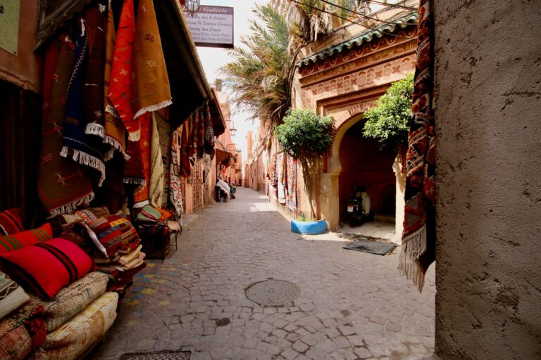 Colourful rugs for sale in a narrow street of the Marrakech medina