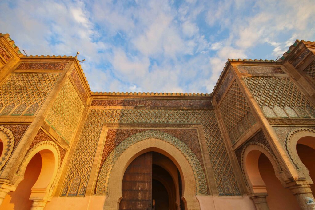 Sunlight illuminates Bab Mansour in Meknes, which can be visited on group tours or independent travel from Fes