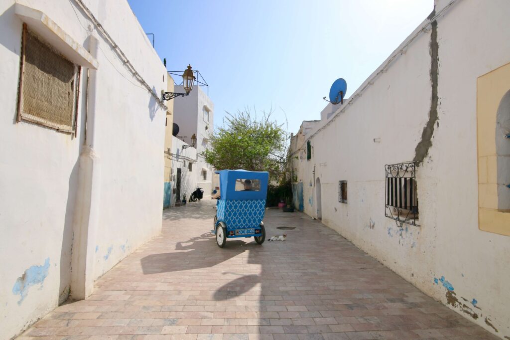 A tuk-tuk drives through the Kasbah of the Oudaias in Rabat, Morocco