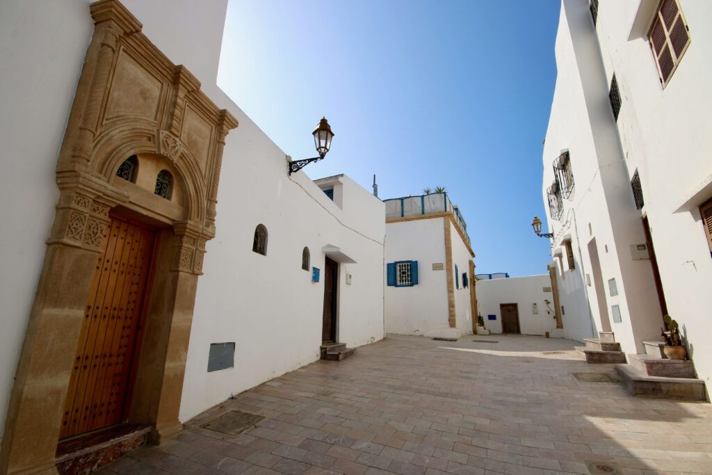 Whitewashed buildings line a street in the Kasbah of the Oudaias in Rabat, Morocco