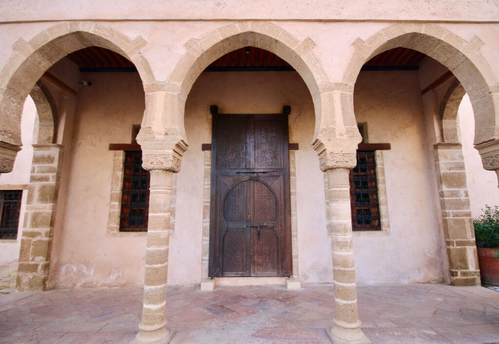 Cultural etiquette in Morocco: Arches front a building in the Andalusian Garden in Rabat