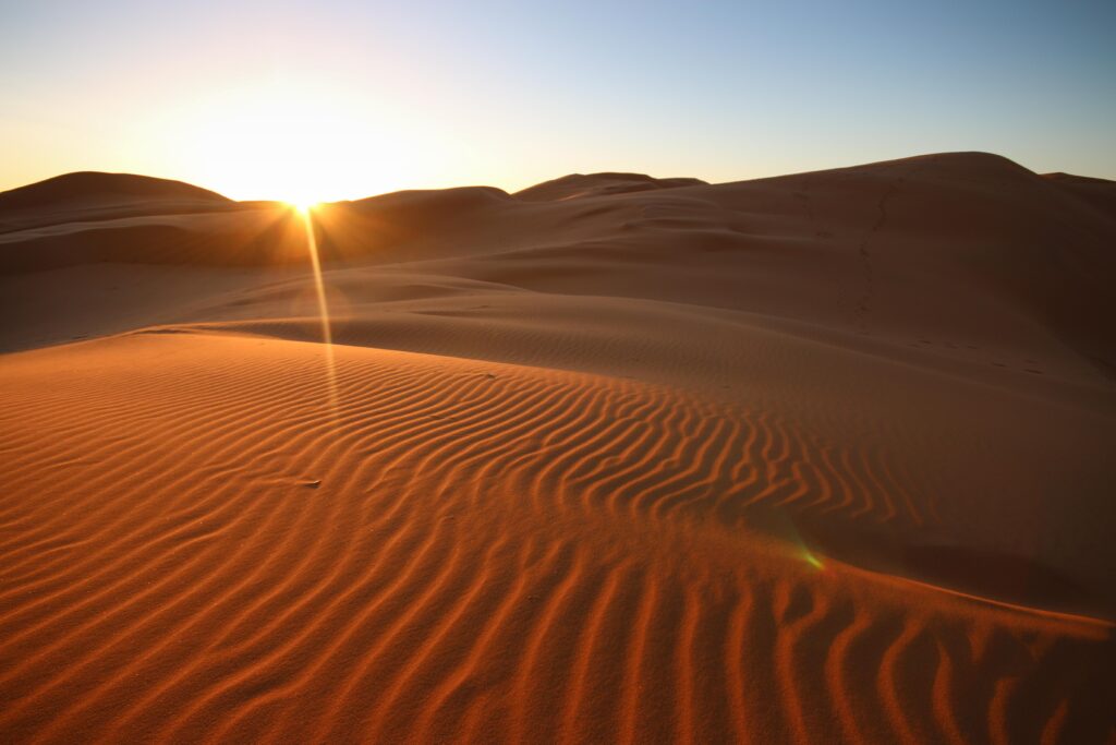 Sunrise over the wind-sculpted dunes of the Sahara Desert, Morocco