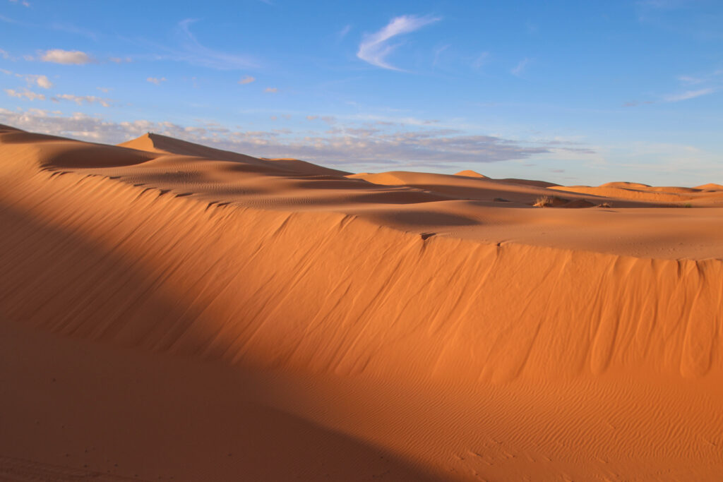 A windswept dune in the Sahara Desert, which can be explored on a solo road trip in Morocco
