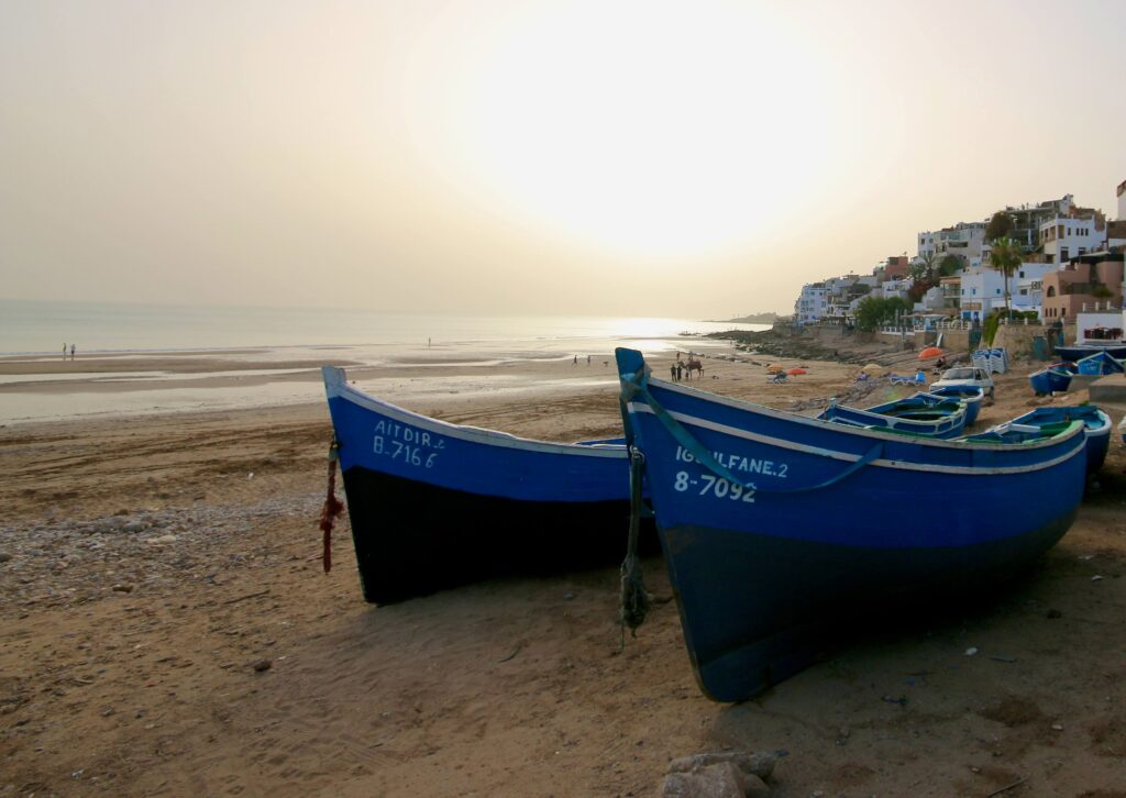 Blue fishing boats on a beach in Taghazout