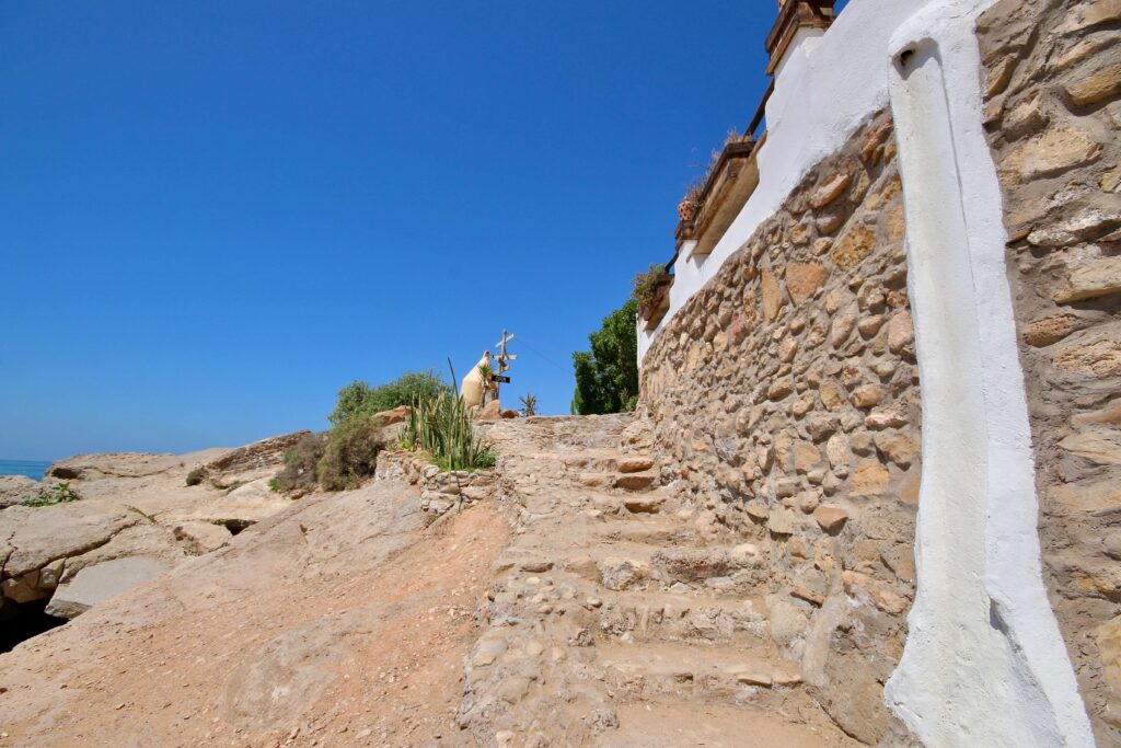 Rocky steps lead along the coastline near Taghazout - a popular destination for surfers and solo travellers in Morocco