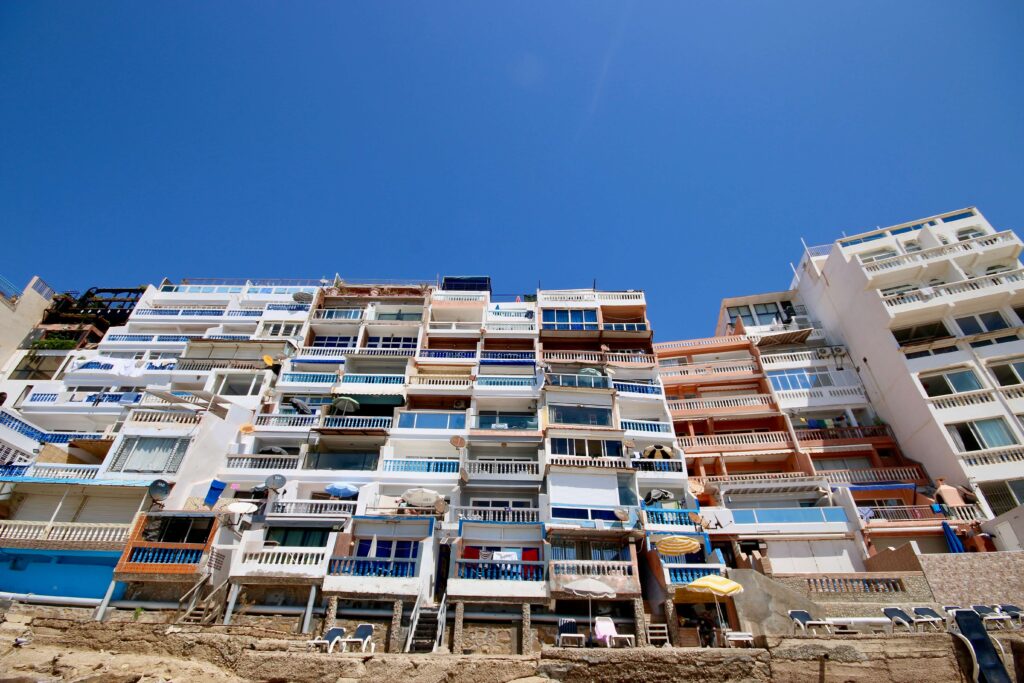 Travelling to Morocco FAQs: Colourful beach apartments in a village near Agadir