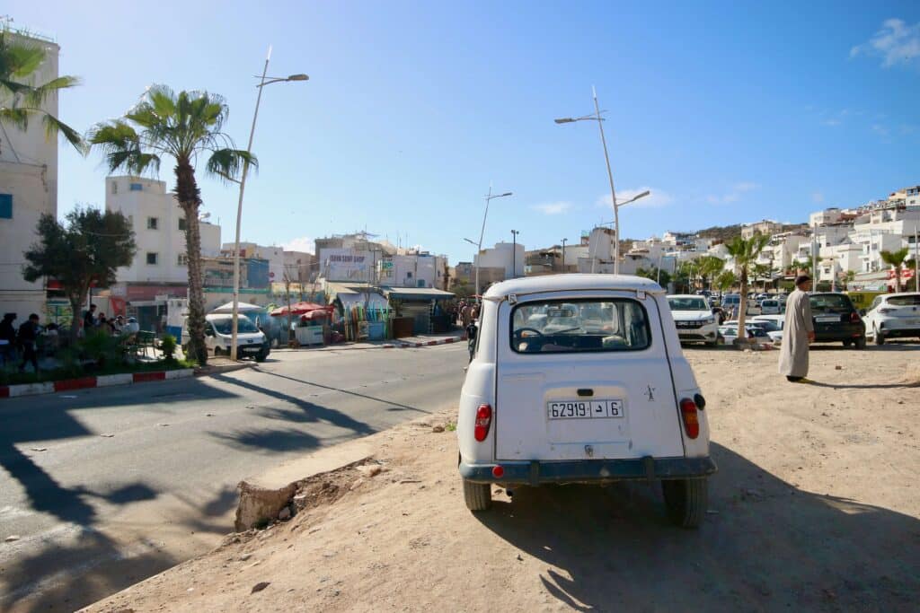 A cute car parked on the side of the road in Taghazout