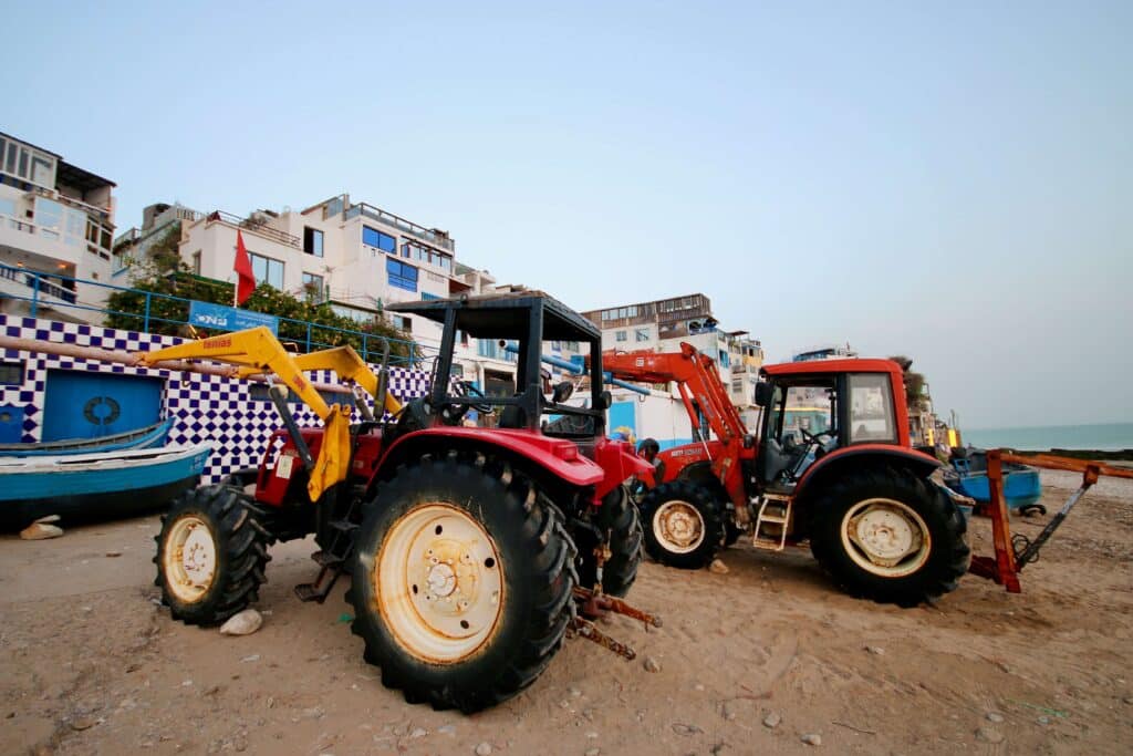Tractors used to haul fishing boats onto the shore in the Amazigh village of Taghazout