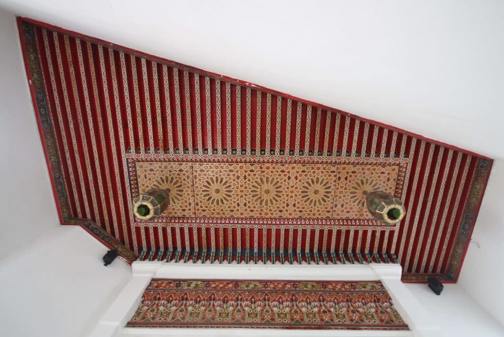 Gazing up at a painted wooden ceiling outside a mosque in Tangier