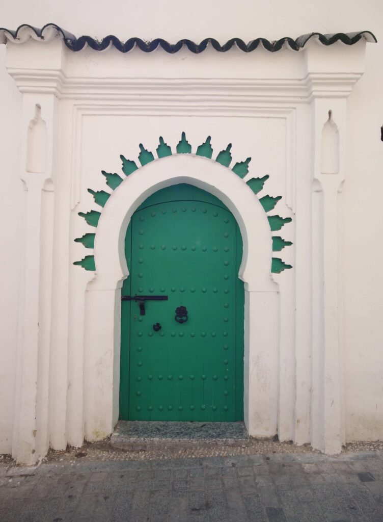 A charming green door in the Kasbah district of Tangier, which can be visited by group tours and independent travellers in Morocco