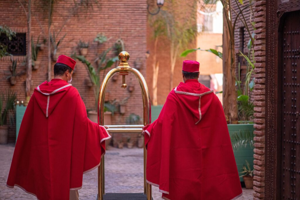 Red-robed staff at La Sultana, a sustainably-designed hotel and one of the best places to stay in Marrakech for solo travellers
