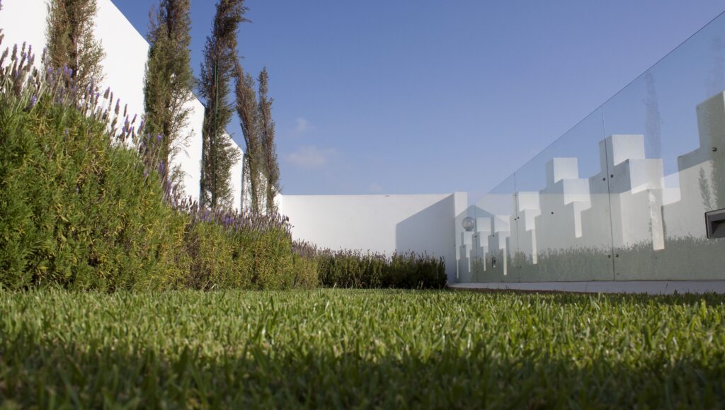 Manicured lawns beside the whitewashed architecture of a contemporary Rabat riad